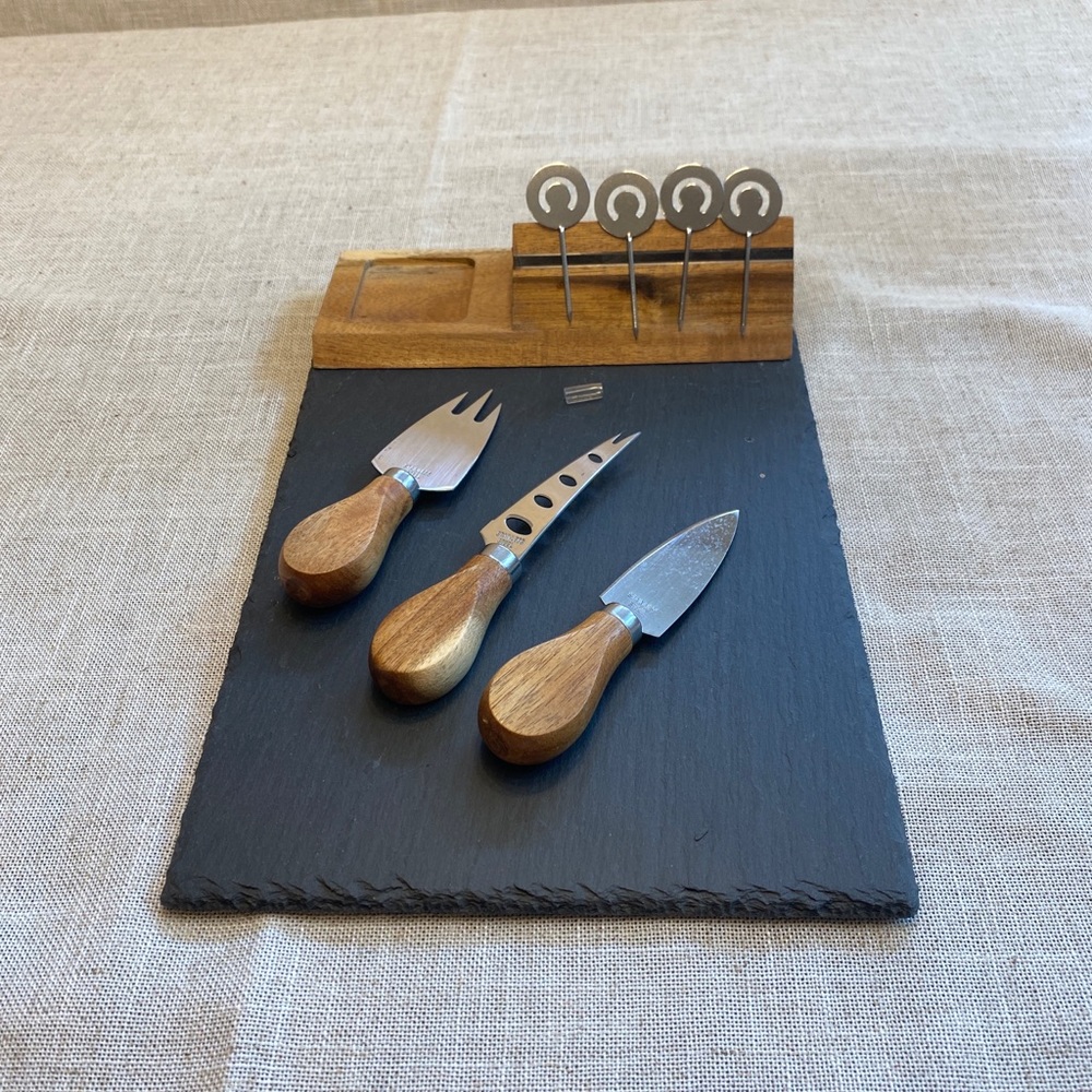 Slate charcuterie cheese board with cutlery and label holder.